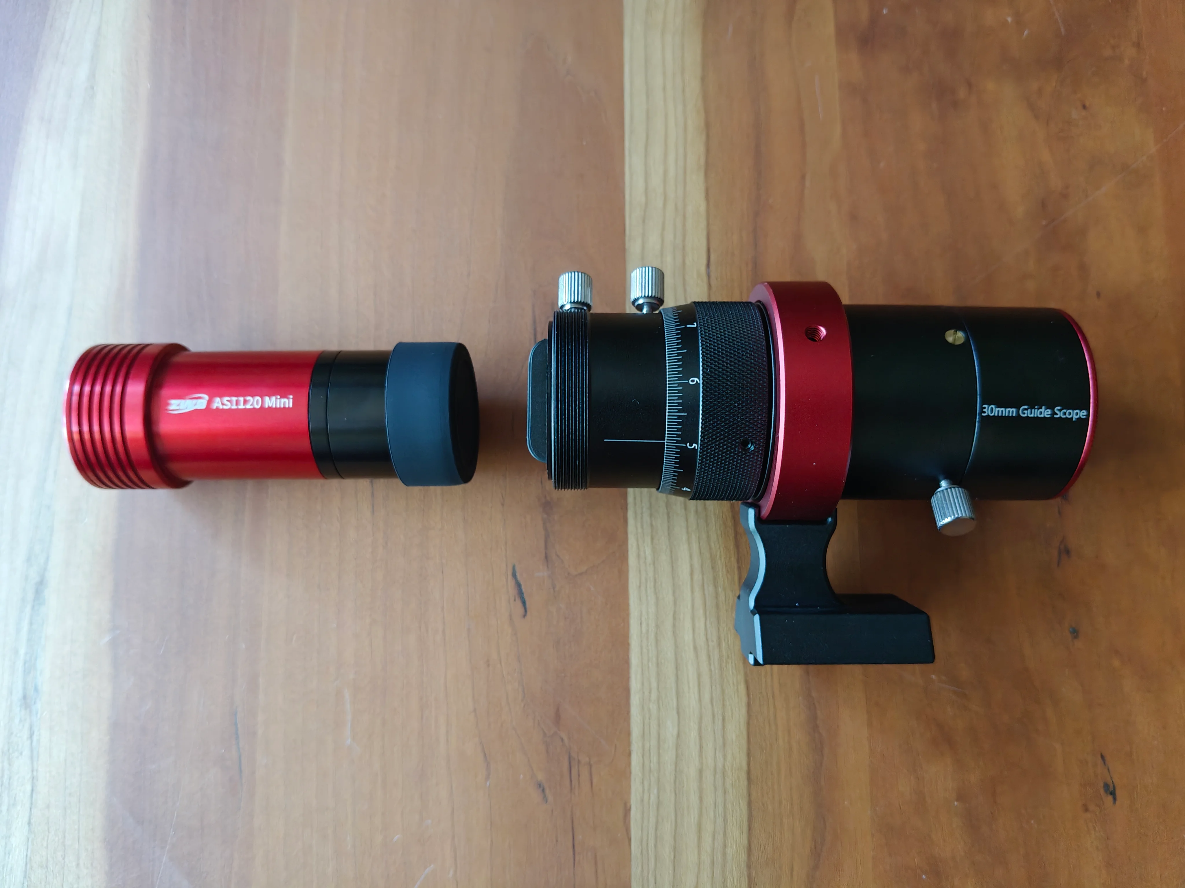 A picture of a mini camera and a guide scope